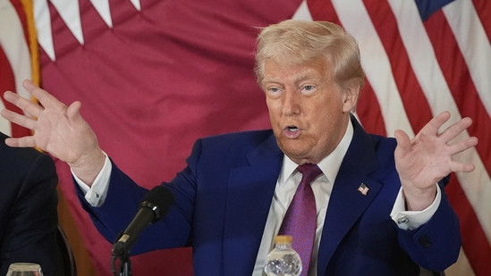 President Donald Trump gestures during a business roundtable in Doha