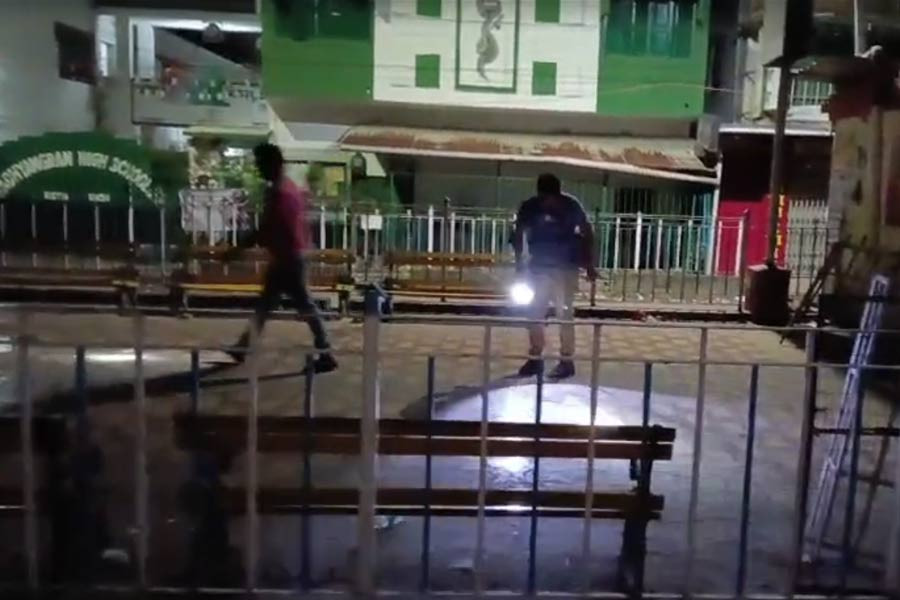 Police inspect the accident site in front of Madhyamgram High School