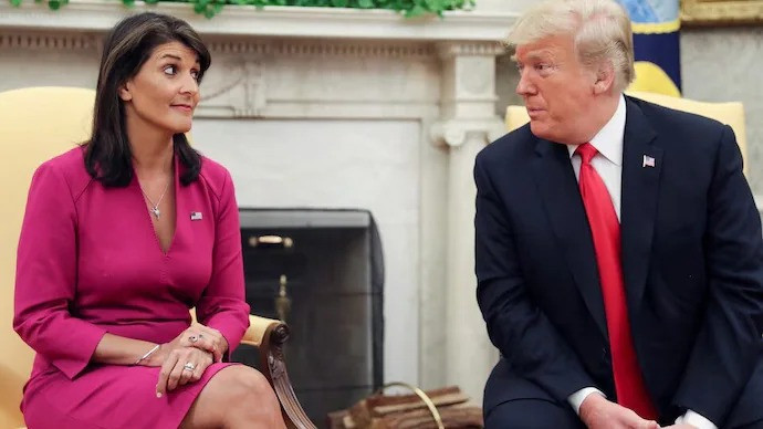 Former US President Donald Trump talks with Nikki Haley