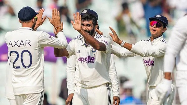 Jasprit Bumrah celebrates with teammates