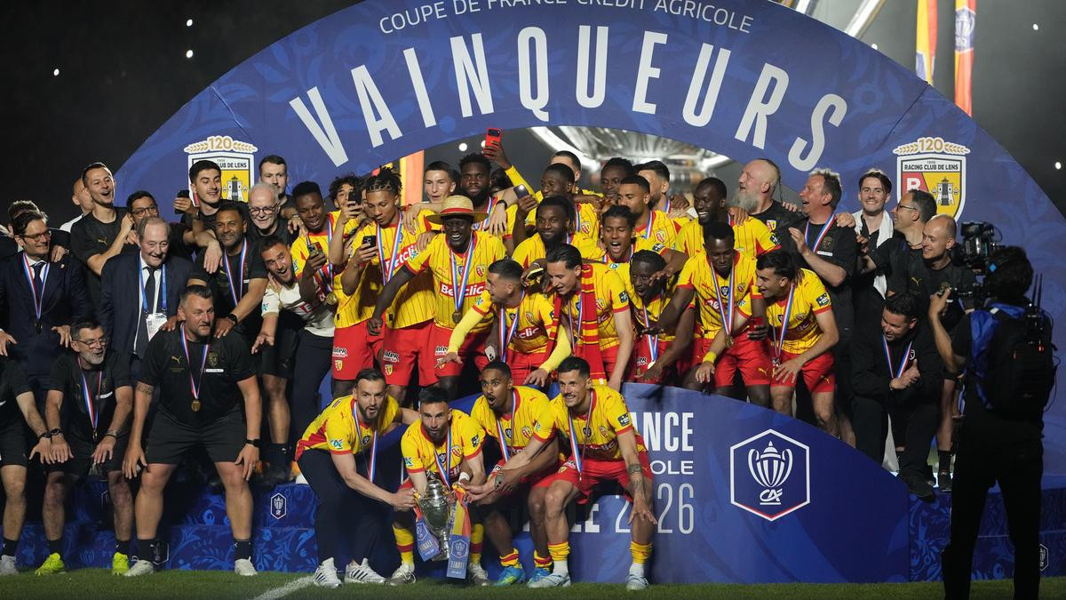 Lens players celebrate with the trophy after winning the French Cup final