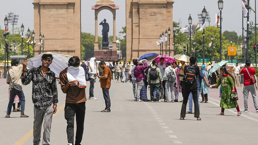 Visitors at the India Gate on a hot summer day, in New Delhi