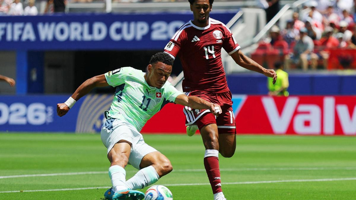 Switzerland's Dan Ndoye in action with Qatar's Homam Ahmed