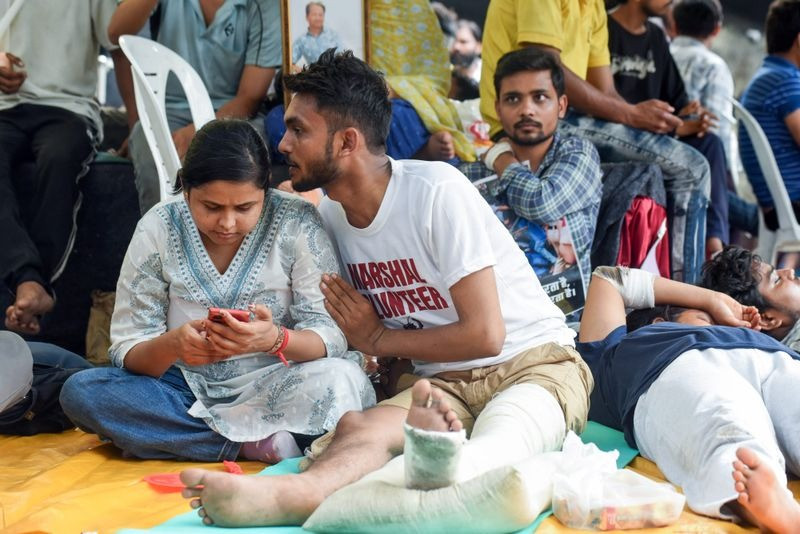 Injured protesters sit at the Jantar Mantar protest site supporting the Cockroach Janta Party